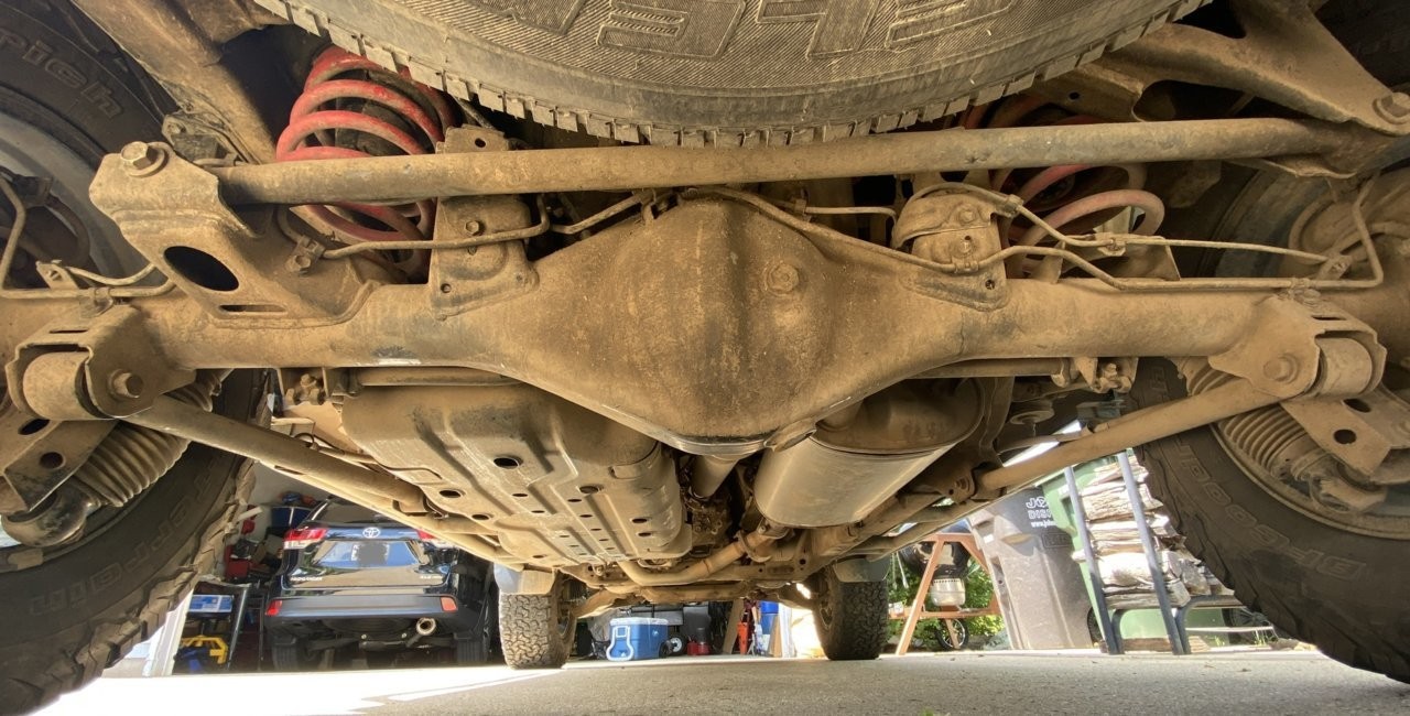 Spraying undercoating on car frame for rust protection in New Hampshire