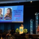 Black SEL leaders on stage at an awards ceremony, celebrating achievements in social emotional learning.