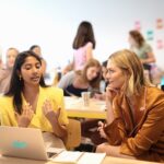 Karlie Kloss engages with young women at a Kode With Klossy coding camp, emphasizing STEM education for girls.