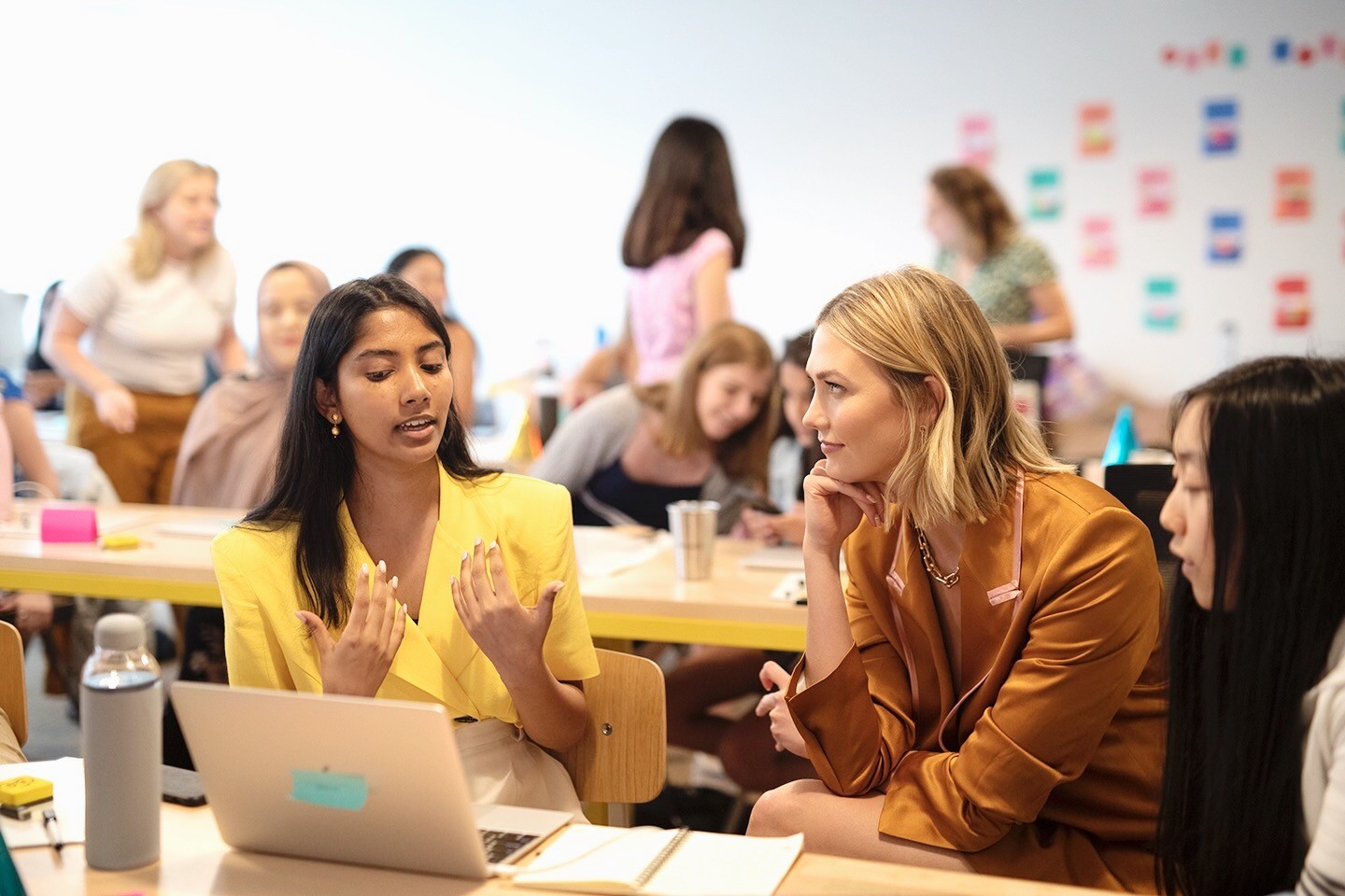 Karlie Kloss engages with young women at a Kode With Klossy coding camp, emphasizing STEM education for girls.