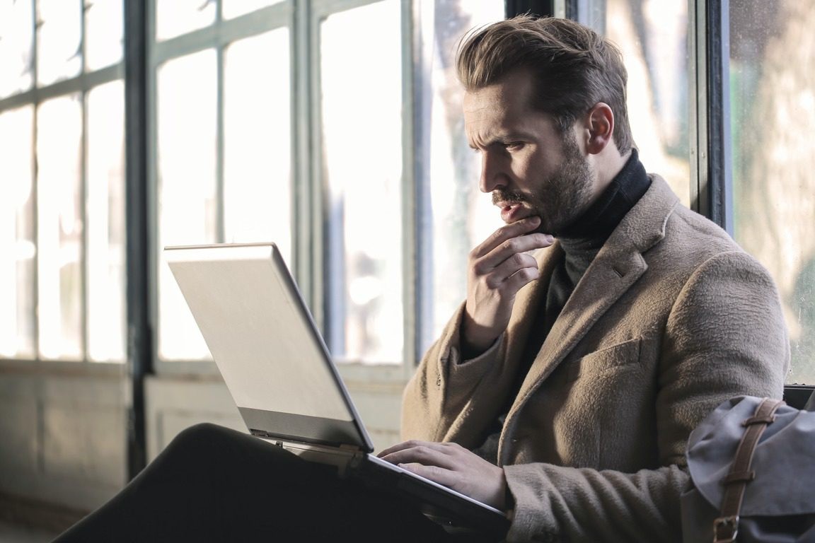 A person reviewing coding job requirements on a laptop, highlighting the importance of understanding necessary skills.