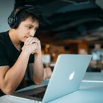 A focused individual working on a laptop, symbolizing the dedication needed for a coding career without a degree.