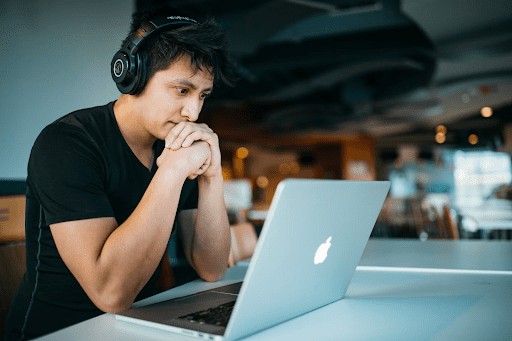 A focused individual working on a laptop, symbolizing the dedication needed for a coding career without a degree.