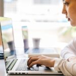 Woman works at laptop