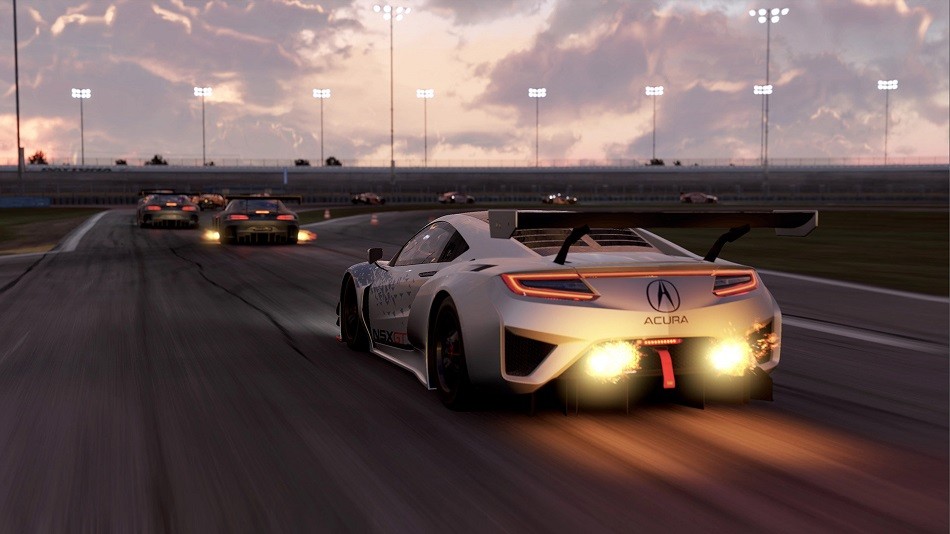 A high-speed race scene in Project Cars 2, showcasing detailed car models and dynamic track environment