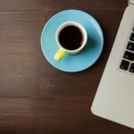 Excited person in cafe with laptop