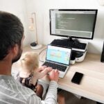 Steven Woods, a DfE Digital developer, coding with his daughter Kitty, illustrating work-life balance in a tech career in the UK